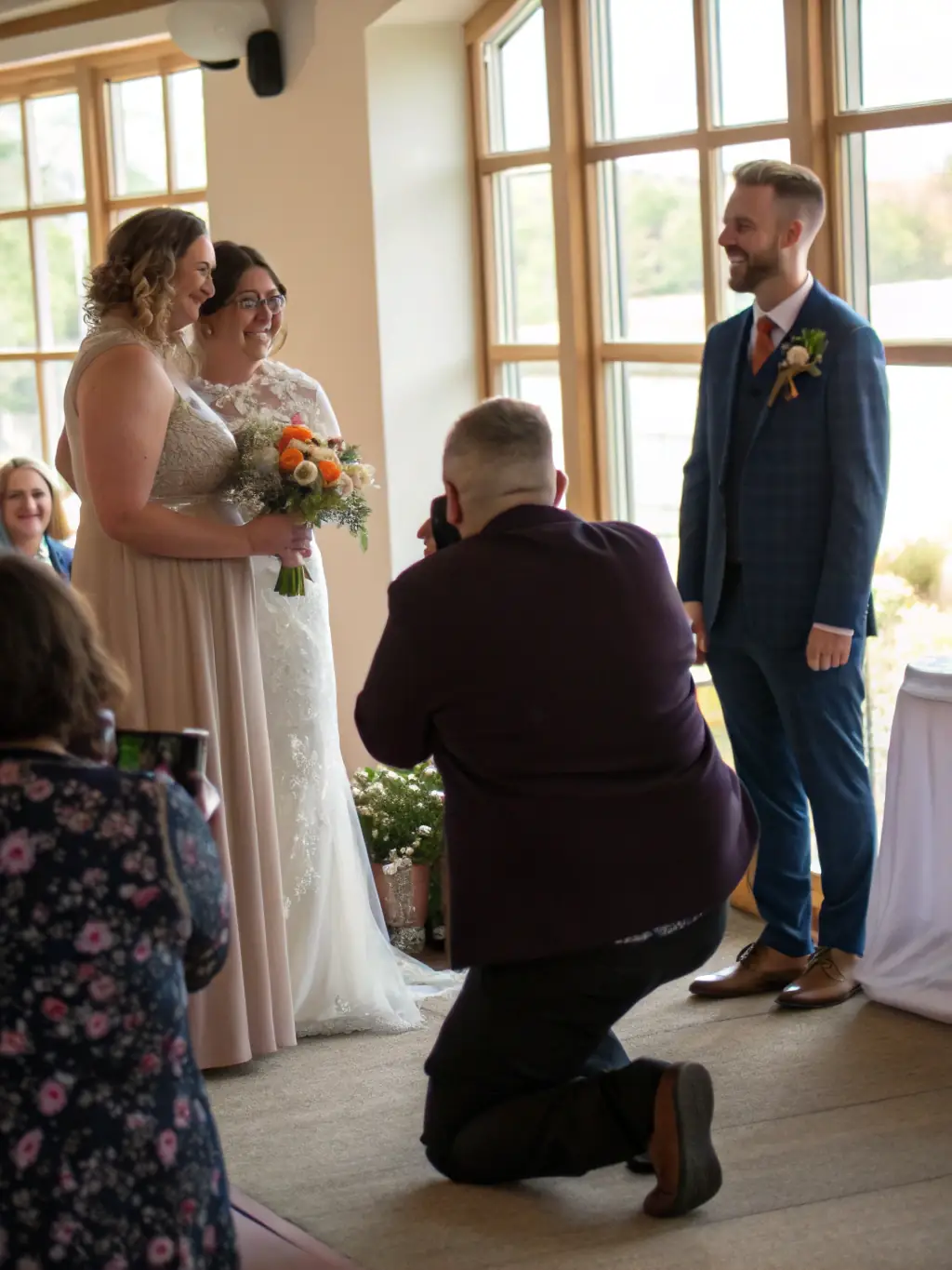 A photographer capturing candid moments at a wedding in the Cape Winelands, South Africa, showcasing event coverage services.